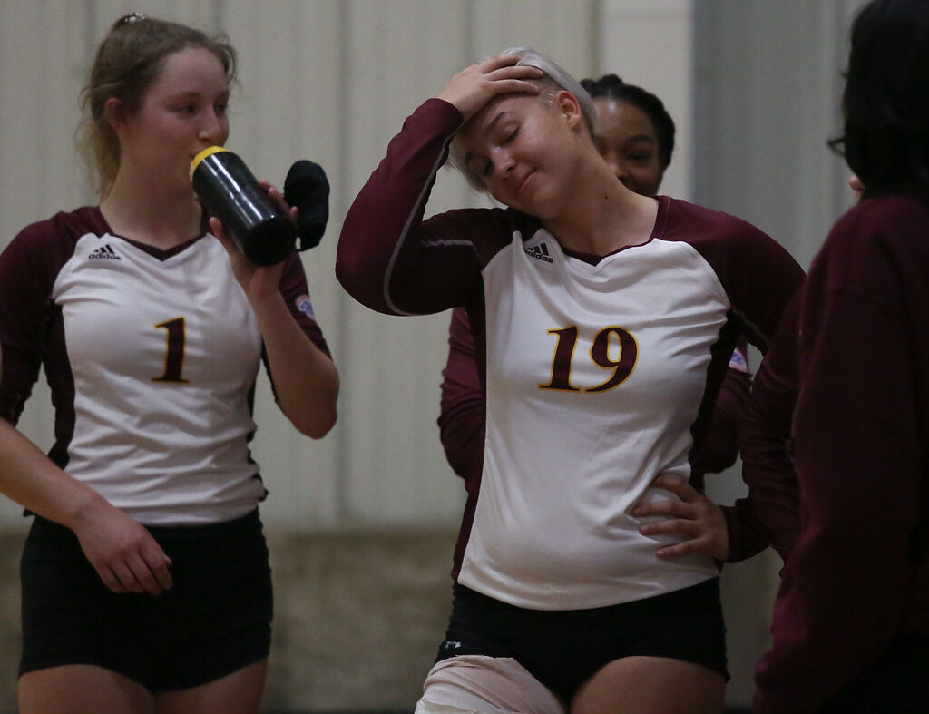 Stephens College sophomore Kayley Lawson, center, pushes her hair off her face